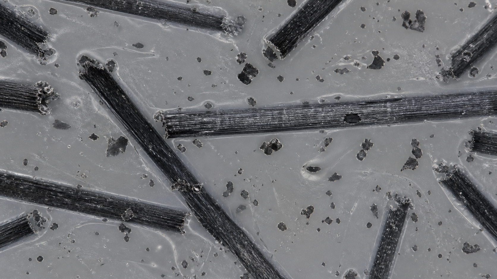 How Conductive Fillers Compromise Polymer Insulation A microscopic view showing conductive carbon fibers embedded within a polymer matrix, illustrating potential pathways for electricity.